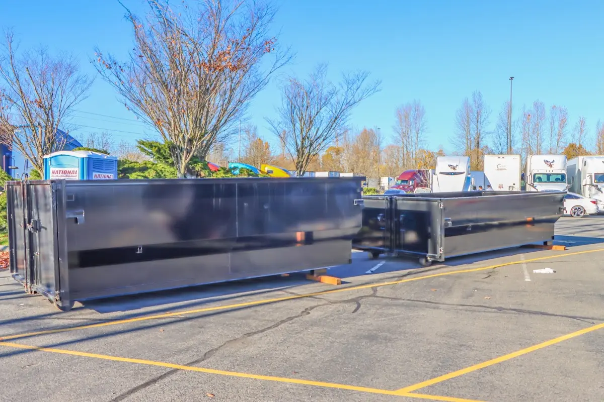 Professional dumpster rental service with roll-off container on residential driveway in Lake City